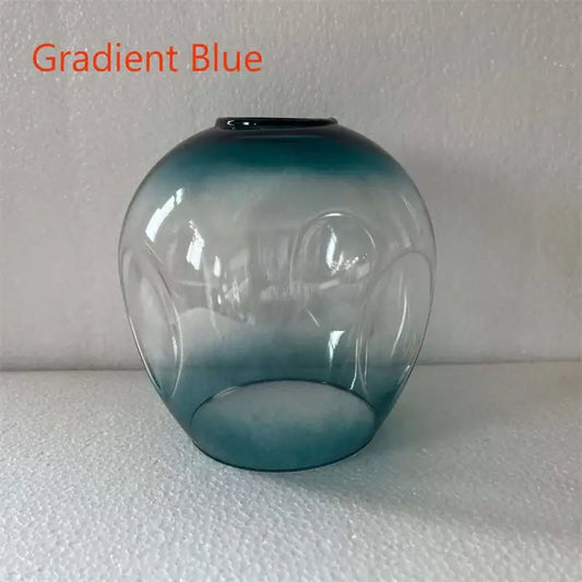 Gradient blue glass vase with smooth rounded body and embossed circles complements modern nordic glass chandeliers design