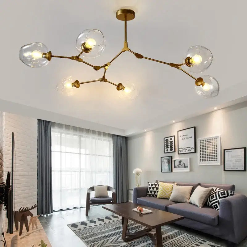 Gold-toned decorbites™ modern nordic glass chandelier with clear globe bulbs and branching design for ceiling lighting