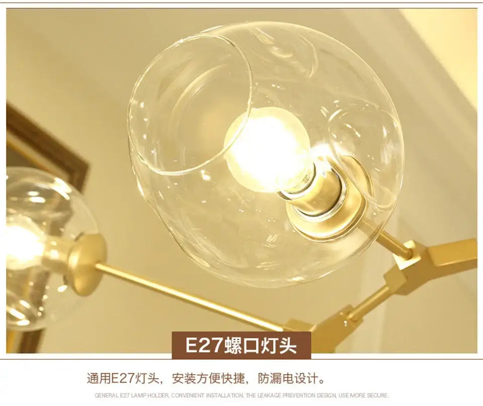 Clear glass globe with brass metal base housing illuminated e27 bulb in decorbites modern nordic glass chandelier