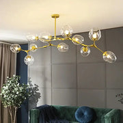 Gold-toned nordic lustre glass chandelier with multiple clear globe shades from DecorBites modern LED collection