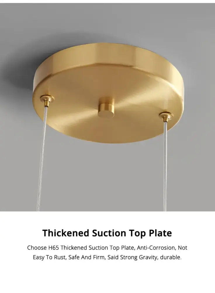Gold-colored circular suction ceiling plate with brushed metallic finish and three mounting points for nordic glass pendant lamp