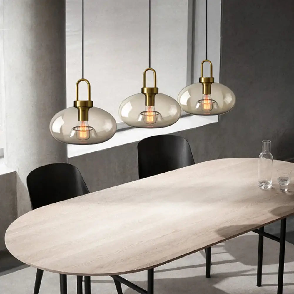 DecorBites modern nordic glass pendant light with brass metal and smoke-gray glass shades for kitchen and restaurant