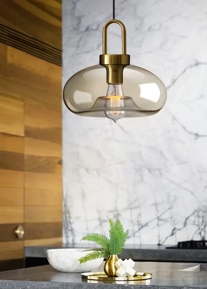 Decorbites modern nordic glass pendant light with smoked glass and brass frame featuring exposed bulb for kitchen use
