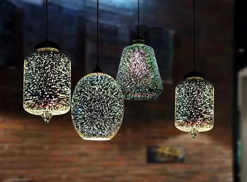 Four hanging glass pendant lights with modern nordic starburst design in iridescent green and silver hues by DecorBites