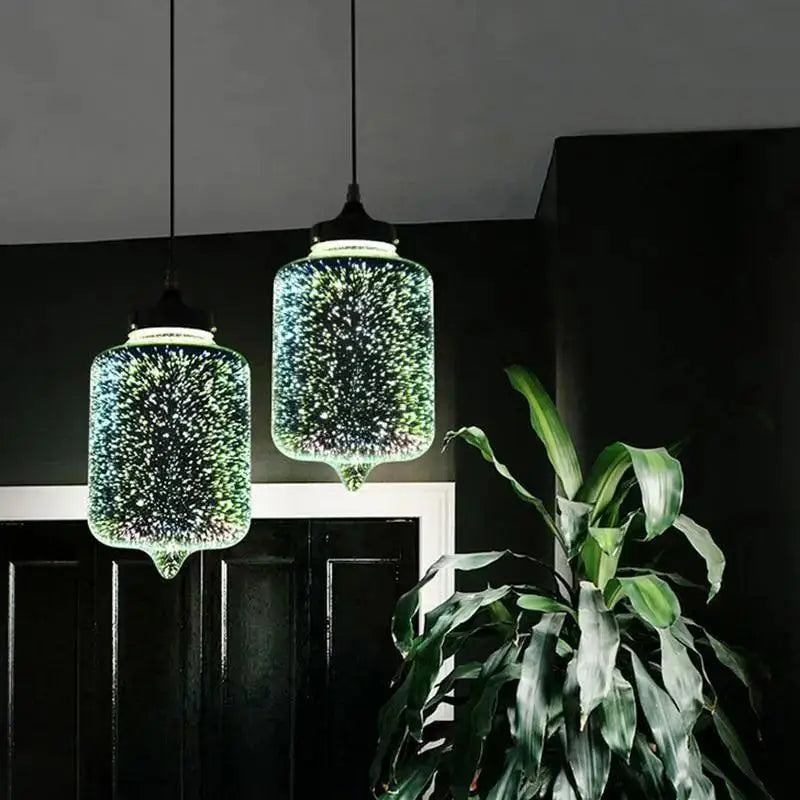 Two decorbites™ modern nordic glass pendant lights with green and blue starburst patterns for stylish lighting