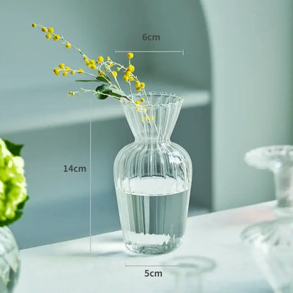 DecorBites™ modern Nordic clear glass vase with vertical ridges and fluted rim holding yellow flowers in water