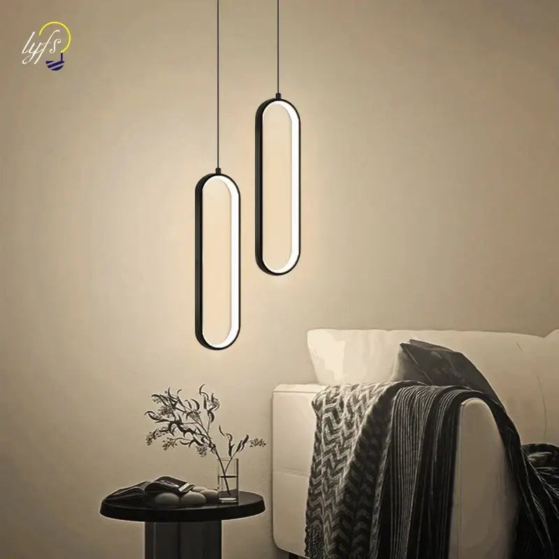 Modern black-framed oval nordic pendant light with glowing led illumination for home decoration by decorbites