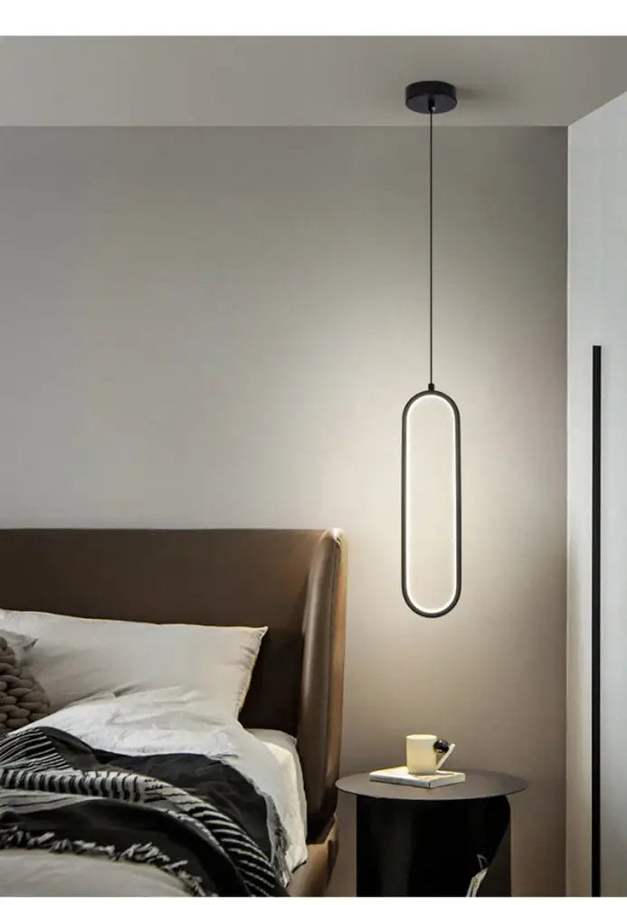 Decorbites modern nordic pendant light in black with sleek elongated oval design and glowing led illumination