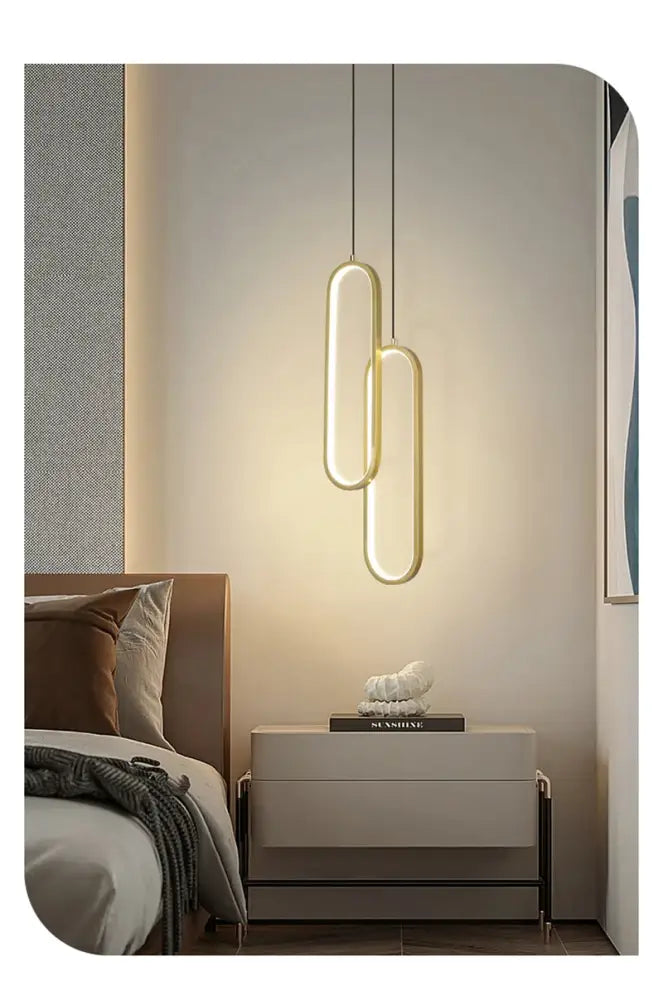 Decorbites™ modern nordic pendant light with gold-toned oval design hangs above bedside table for home decoration