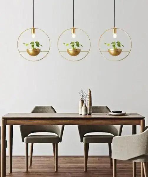 Three identical gold-toned metal circular pendant lights with integrated bowl-shaped planters featuring small green plants modern nordic planter lighting