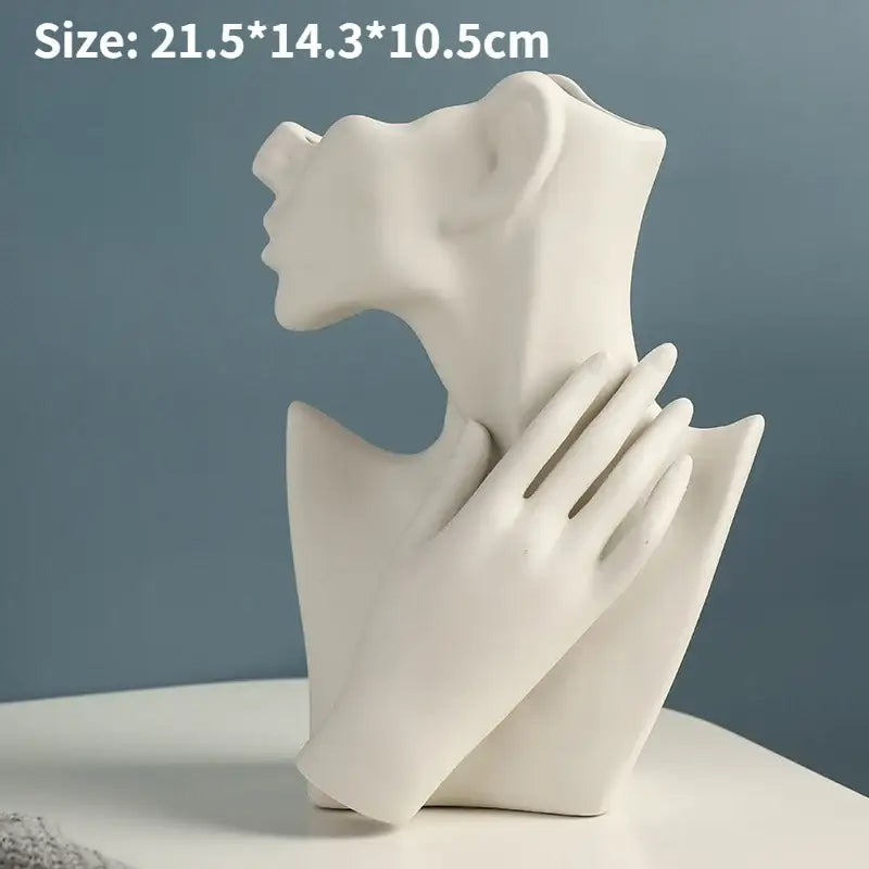 White ceramic nordic style ceramic body vase sculpture of a woman with hand resting on her neck by DecorBites