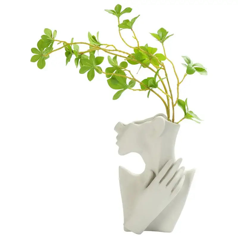 White ceramic nordic style ceramic body vase shaped like a woman with hand gently resting on her chest by DecorBites