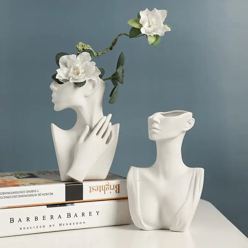 White ceramic nordic style ceramic vase shaped like a woman’s head with open mouth cavity for flowers by DecorBites™