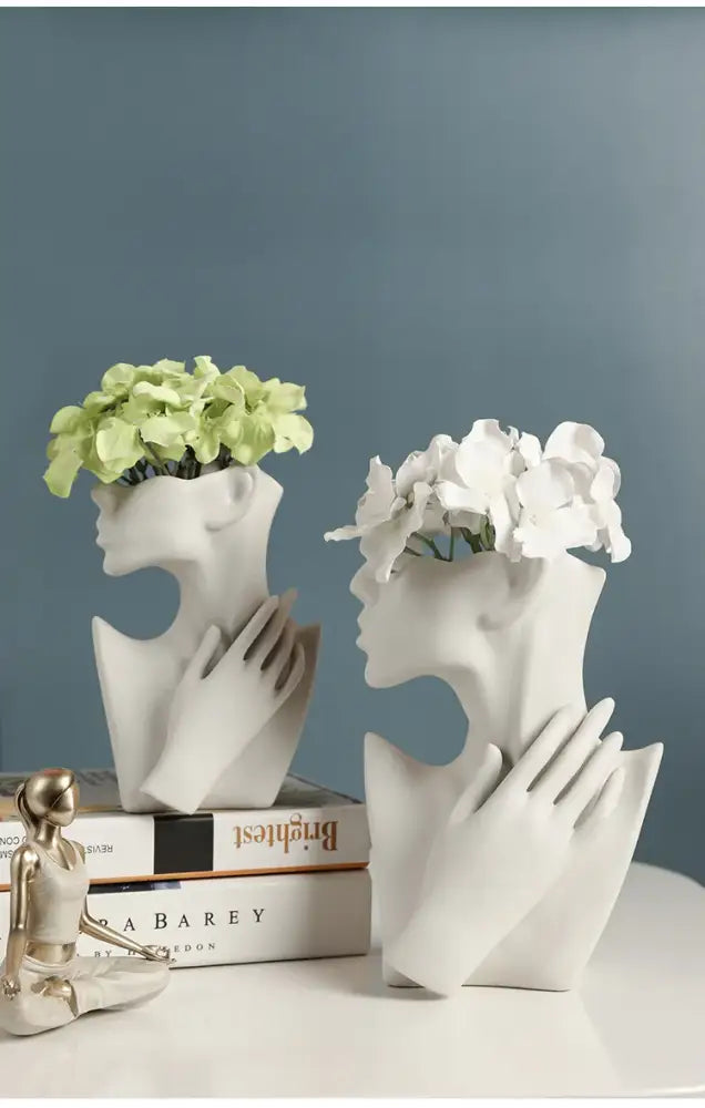 White ceramic nordic style ceramic vases shaped like stylized female heads cupping bouquets by decorbites™