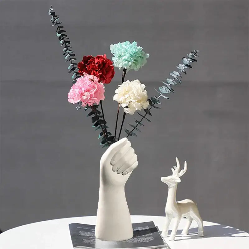 Modern nordic style white ceramic hand vase holding colorful artificial flowers by decorbites