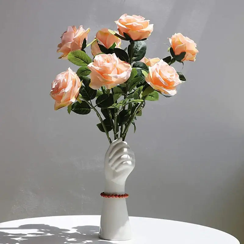 A white ceramic hand vase holding roses in modern nordic style by decorbites with nordic style design