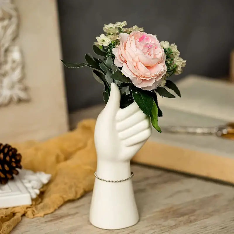 White ceramic hand vase by decorbites holding pink and white flowers in modern nordic style design
