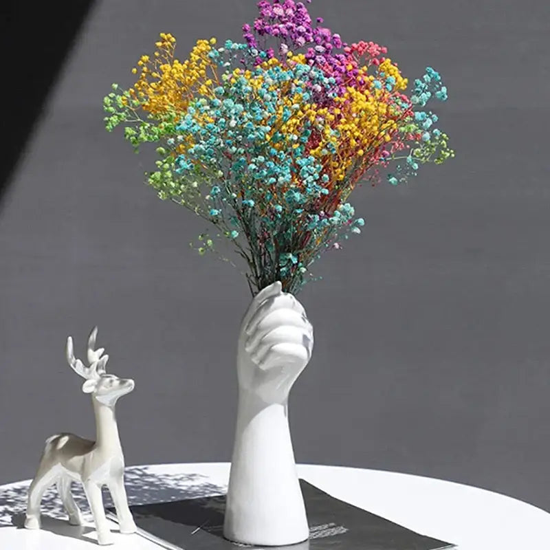 DecorBites™ modern nordic style white ceramic hand vase holding a vibrant rainbow dried babys breath bouquet