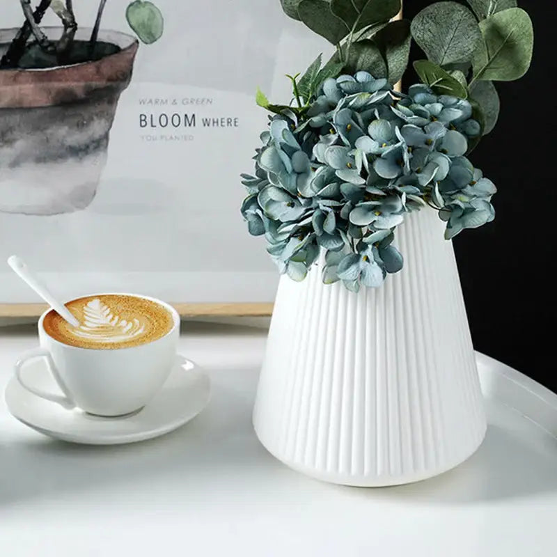 White ribbed ceramic vase holding blue hydrangeas for modern nordic home decor by DecorBites creative vase home
