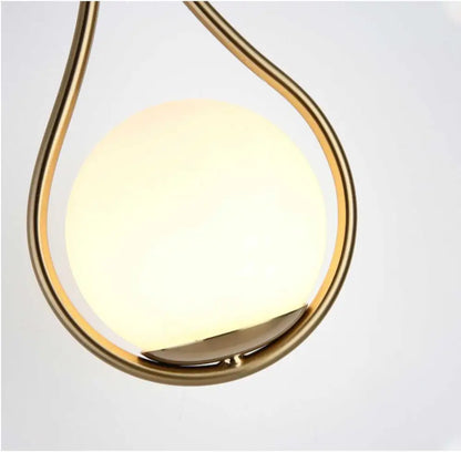 Decorbites modern nordic livi wall lamp with teardrop frosted glass globe and polished brass frame emitting warm glow
