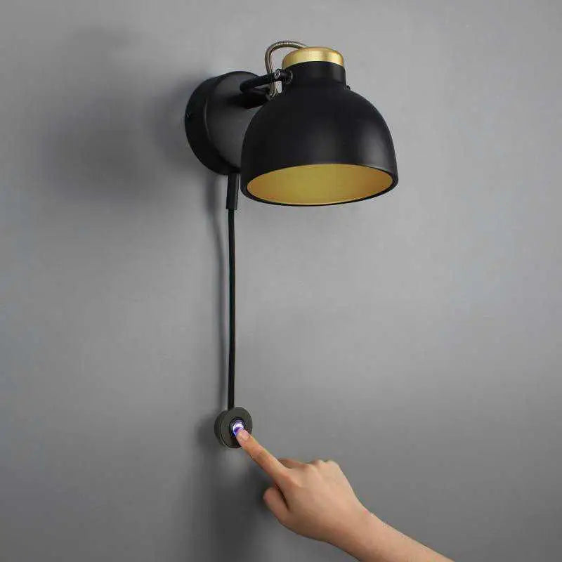 Black industrial-style DecorBites™ Modern Nordic wall sconce with gold interior, brass accents, adjustable arm, and touch control