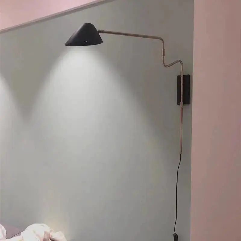 Black conical shade anneke wall sconce with articulated metallic arm and dark rectangular base from DecorBites modern nordic wall sconce