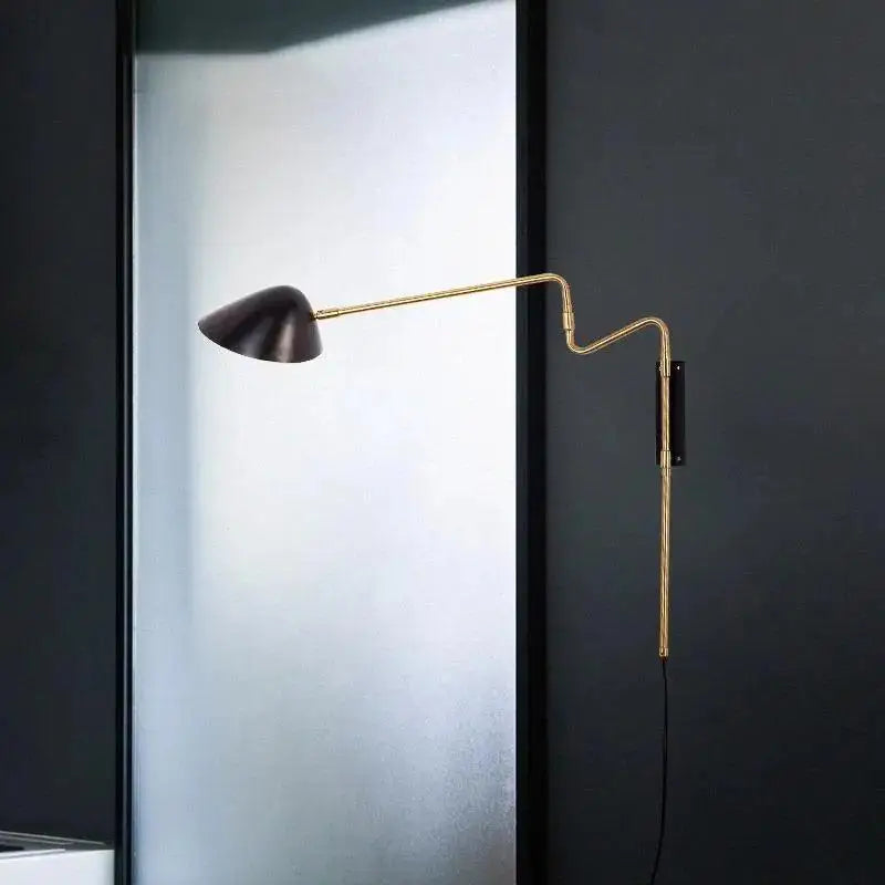 A sleek black conical wall sconce with a gold articulated arm for adjustable lighting from DecorBites anneke wall sconce
