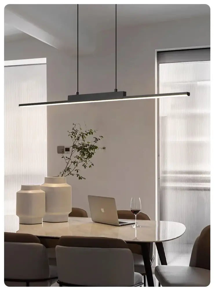 Modern black linear pendant light with sleek minimalist design hanging above dining table for dining room use