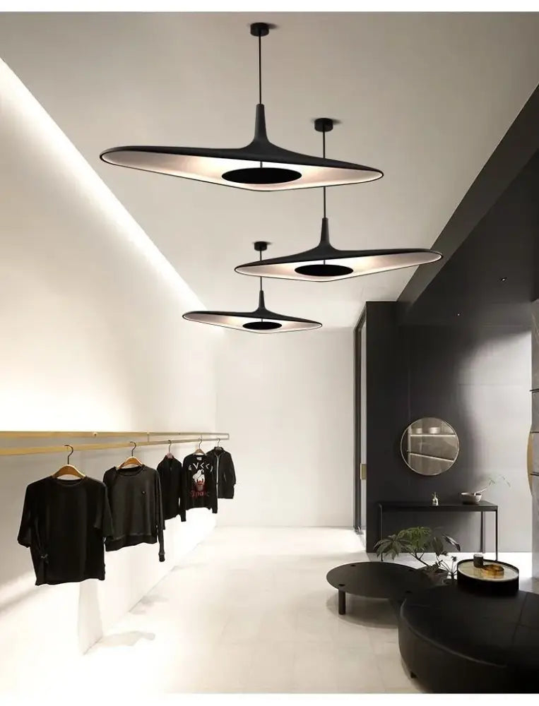 Modern black resin pendant lamp with sleek disc-shaped design for dining room featuring changeable light options