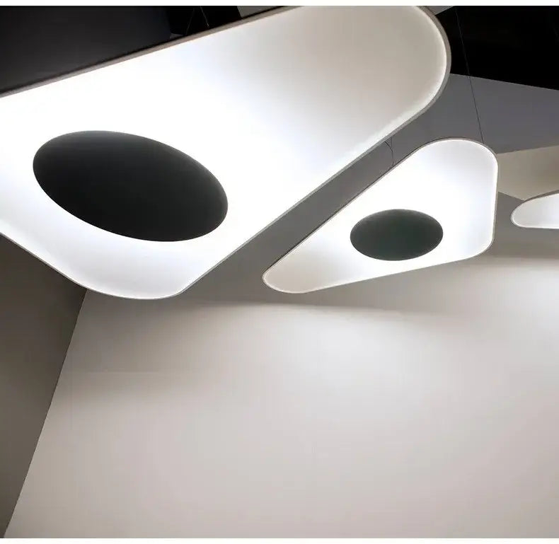 Decorbites modern resin pendant lamp with sleek white acrylic body and black oval cutouts for dining room lighting