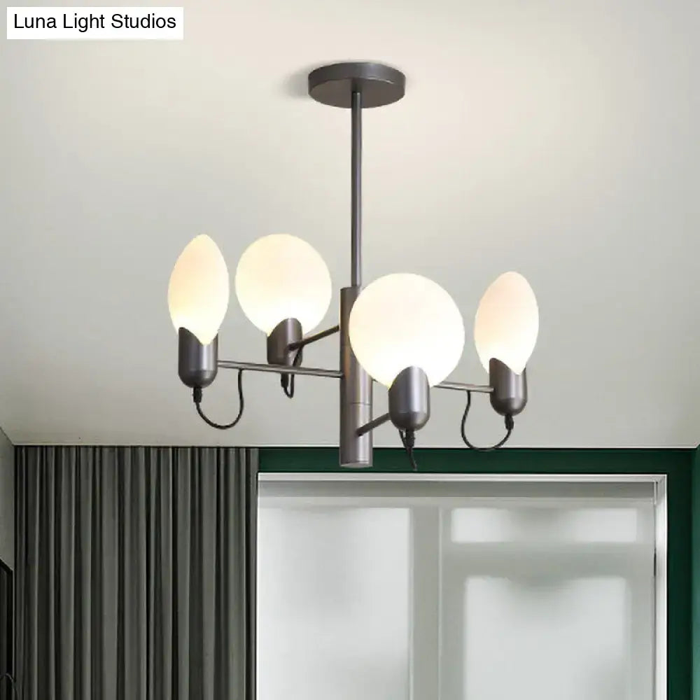 Modern matte black chandelier with four frosted glass globes paired with silver gray opal glass ceiling light design