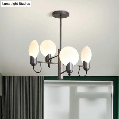 Modern matte black chandelier with four frosted glass globes paired with silver gray opal glass ceiling light design