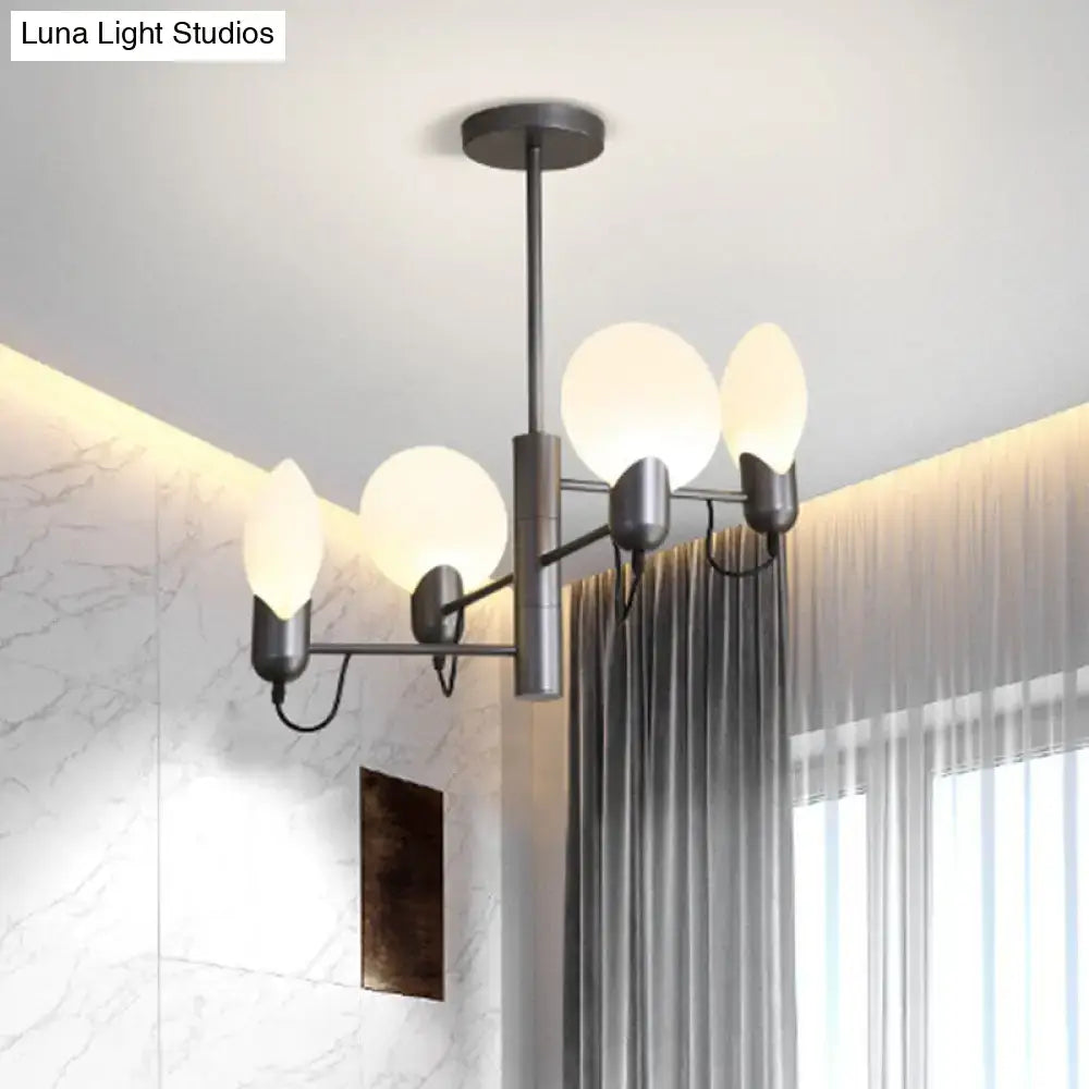 Modern black metal chandelier with five frosted globe shades paired with a silver gray opal glass ceiling light