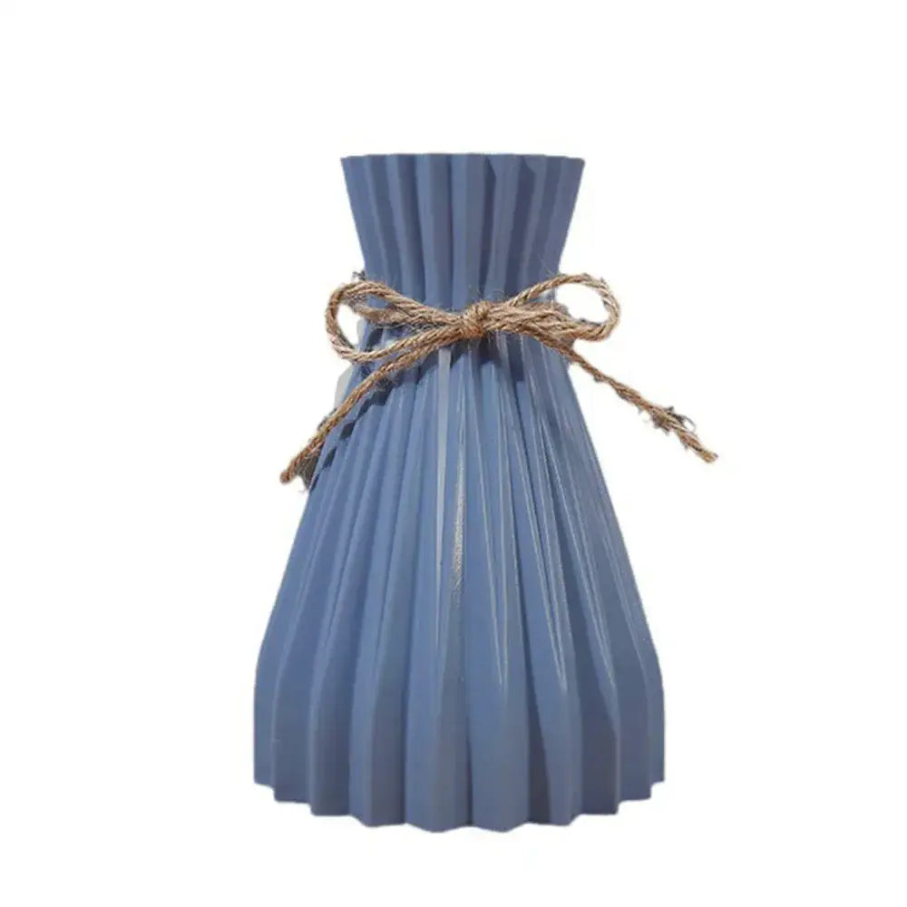 Blue pleated ceramic flower vase with rustic twine bow for dry flowers in a modern simple decor style by DecorBites™