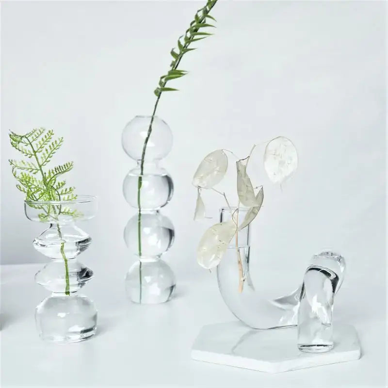 Clear glass vases set with spherical and curved designs featuring delicate greenery for decorate root width 750px height display