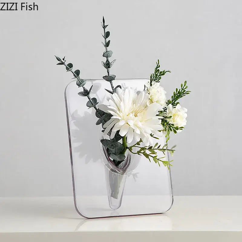Decorbites™ modern transparent square vase is a clear rectangular wall-mounted square vase holding white flowers and greenery