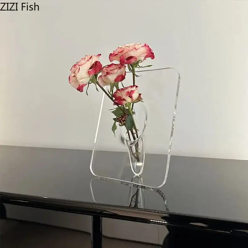 DecorBites modern transparent square vase is a clear acrylic square vase with curved interior holding pink and white roses