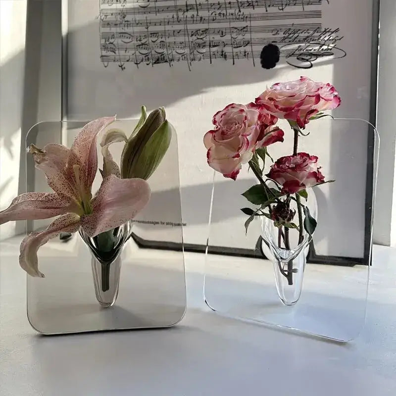 Clear acrylic modern transparent square vase with curved base holding pink and white flowers by decorbites