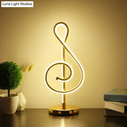 Golden neon table lamp shaped like a musical treble clef with power switch modern twist night table light from decorbites