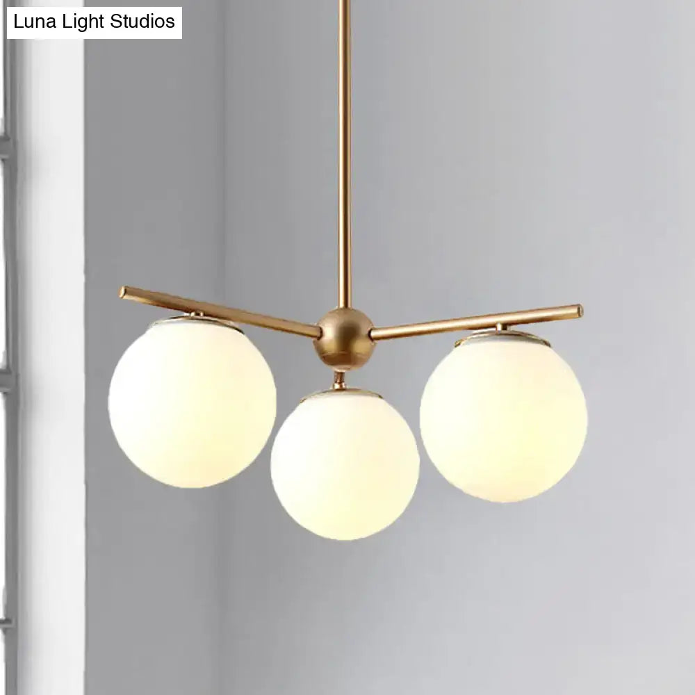 DecorBites™ modern pendant light with brass finish and three white frosted glass shades for bedroom ceiling lighting