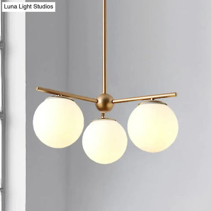 DecorBites™ modern pendant light with brass finish and three white frosted glass shades for bedroom ceiling lighting