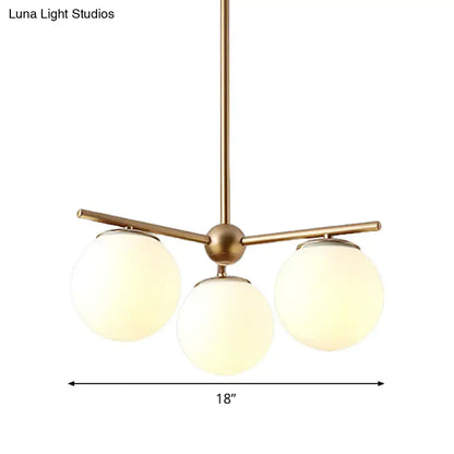 DecorBites modern gold chandelier with three white frosted glass shades for bedrooms and living spaces