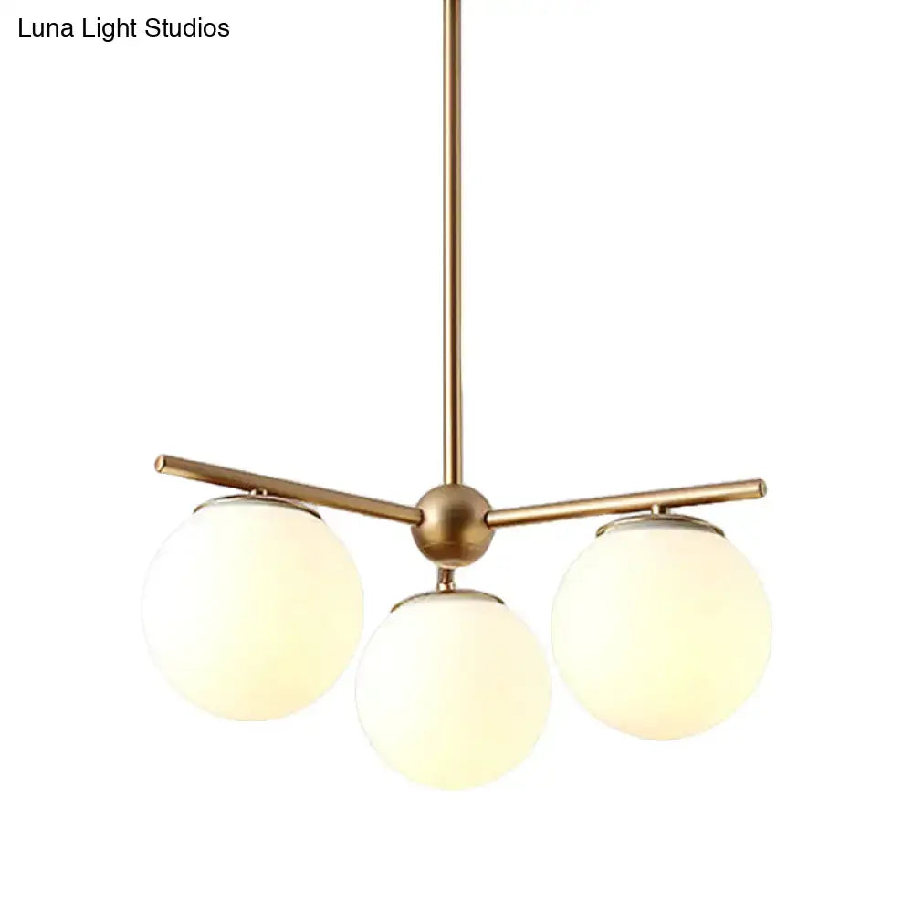 DecorBites modern chandelier with three brass-finished arms and white frosted glass shades for bedrooms