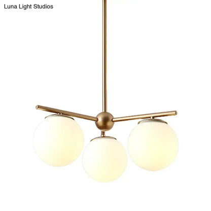 DecorBites modern chandelier with three brass-finished arms and white frosted glass shades for bedrooms