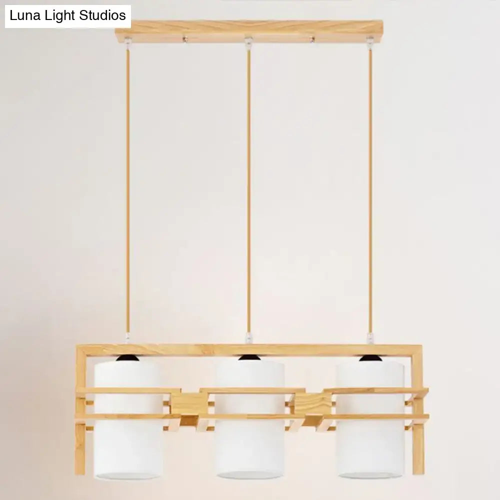 Minimalist modern wooden pendant light with three white cylindrical fabric shades compatible with e27 bulb base