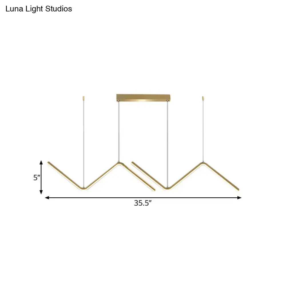 Modern gold-toned metal hanging lamp with geometric design and minimalist finish for dining room by DecorBites