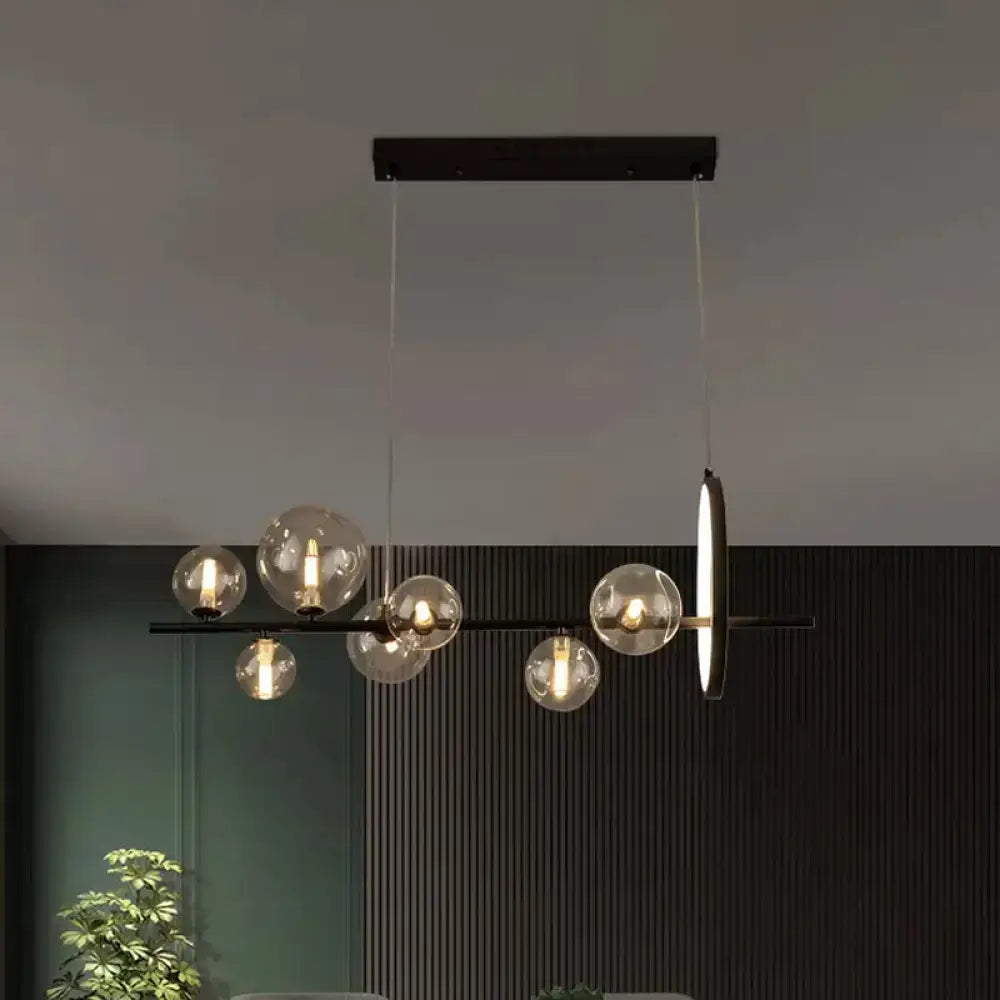 DecorBites™ modernist black metal island light with seven clear glass globe bulbs and circular hanging pendant design