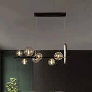 DecorBites™ modernist black metal island light with seven clear glass globe bulbs and circular hanging pendant design