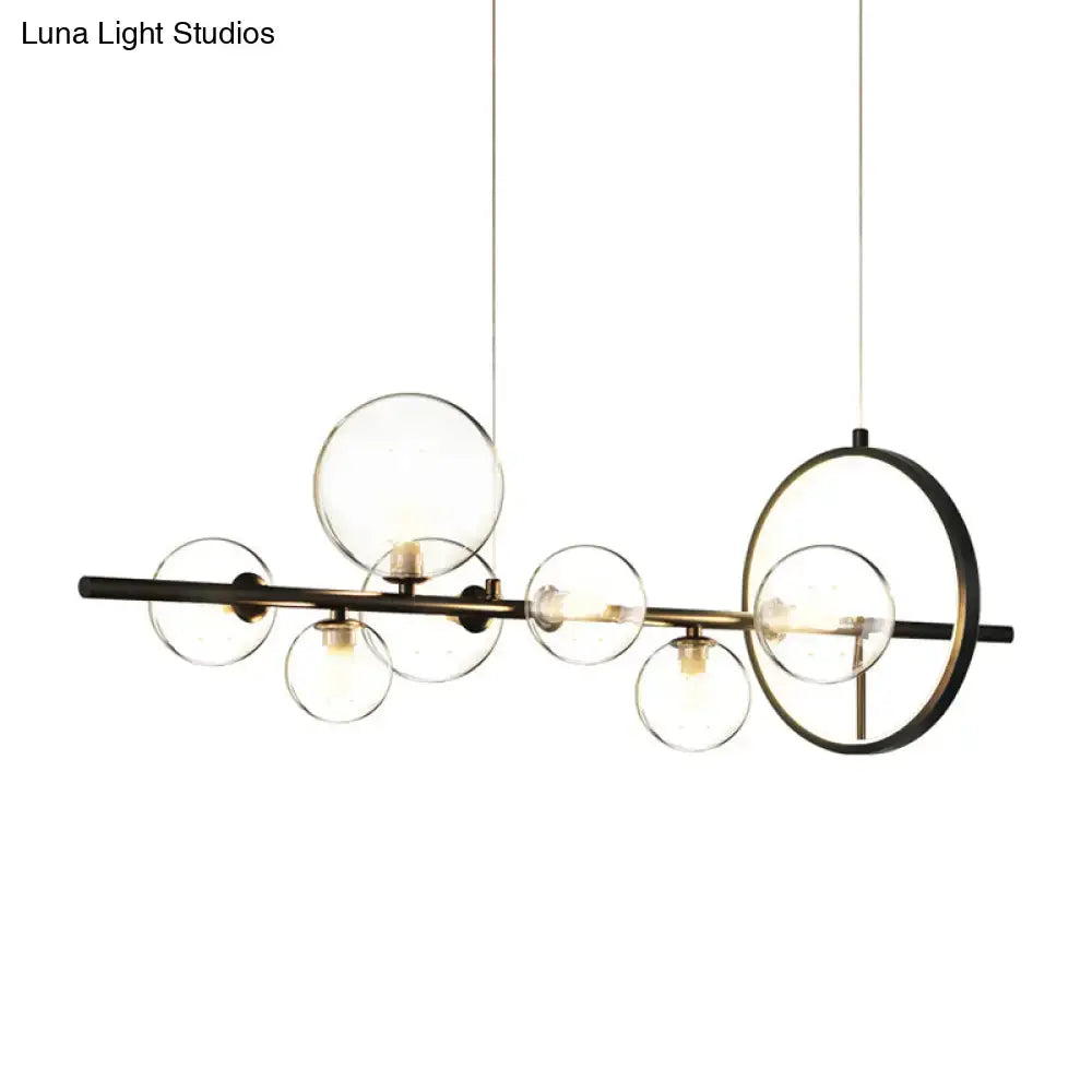 DecorBites modernist black and brass hanging pendant island light with seven clear glass spheres for restaurants