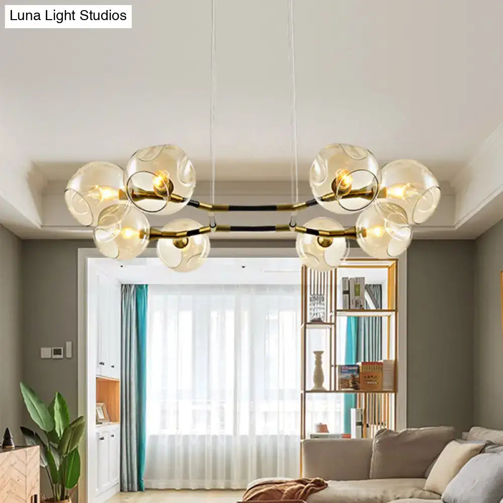 Modern glass globe chandelier pendant light with brass accents and black bars for living room lighting